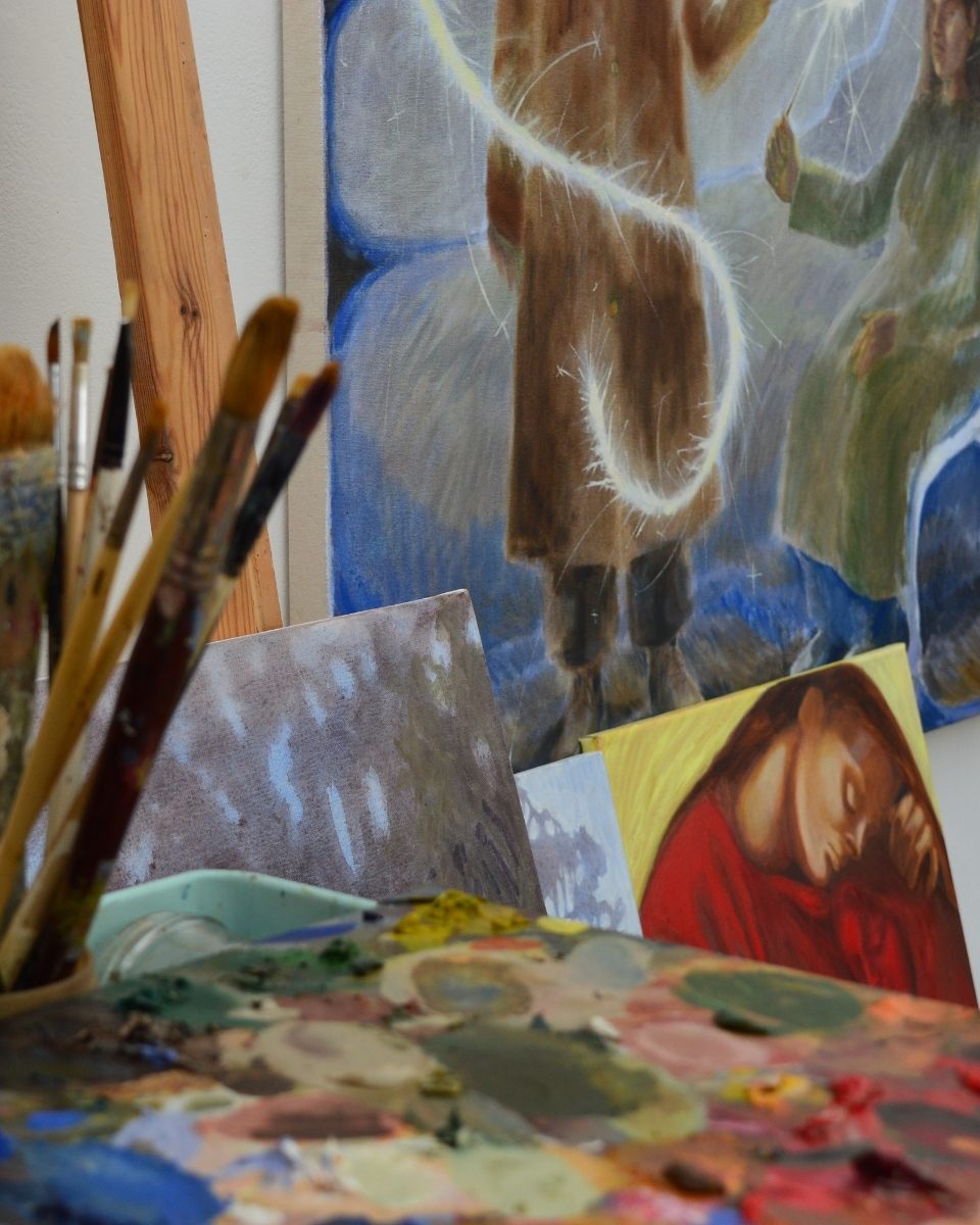 Detail shot of Robyn Packham’s studio, showing snippets of her expressive figurative oil paintings in progress.