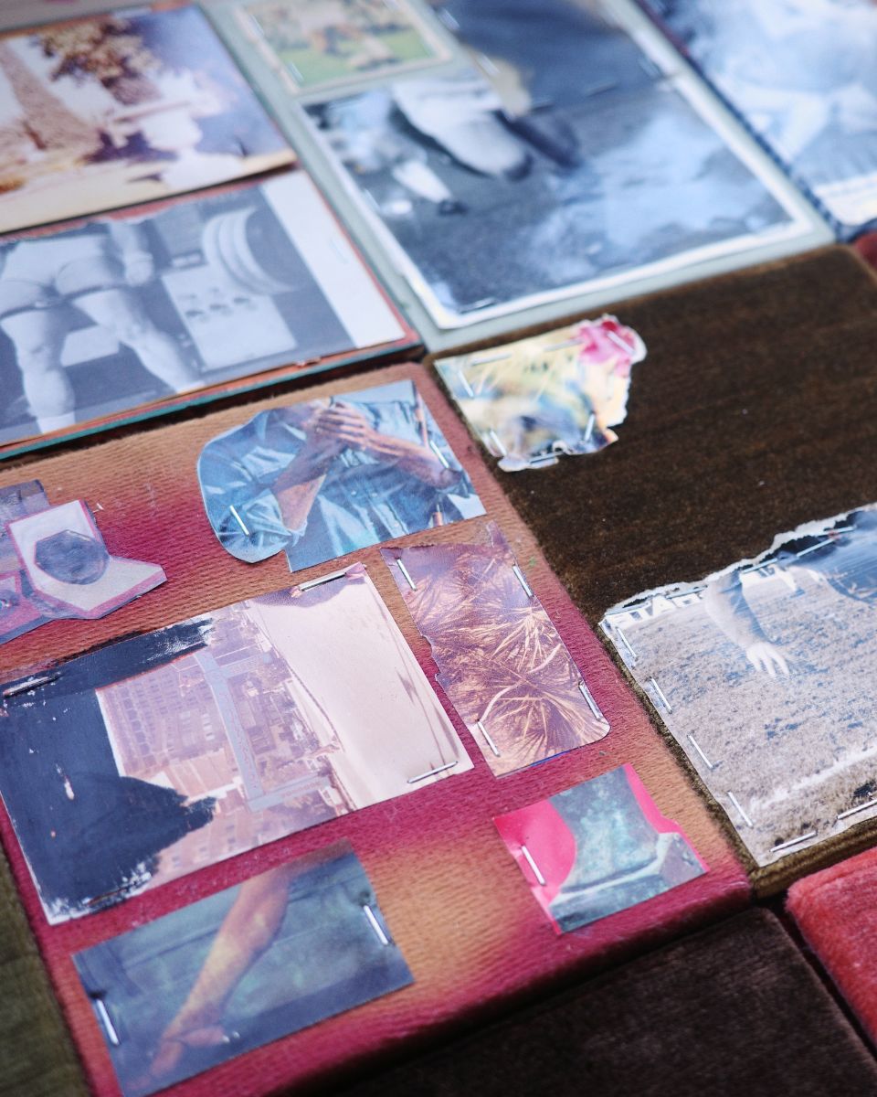 Close-up of stapled photographic media and film prints layered onto a raw fabric canvas by Ruba Nadar.