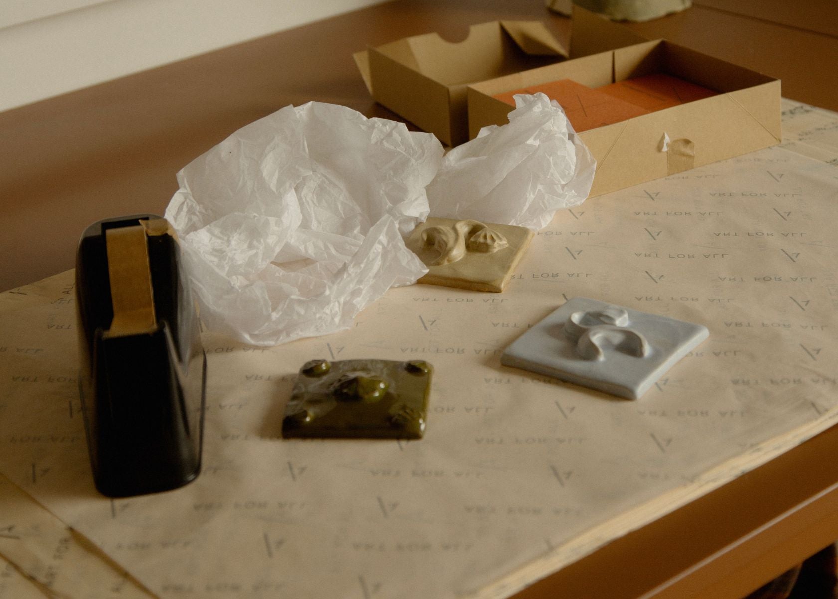 Fanny Schultz ceramic tiles being carefully wrapped for shipping at the Partnership Editions studio.