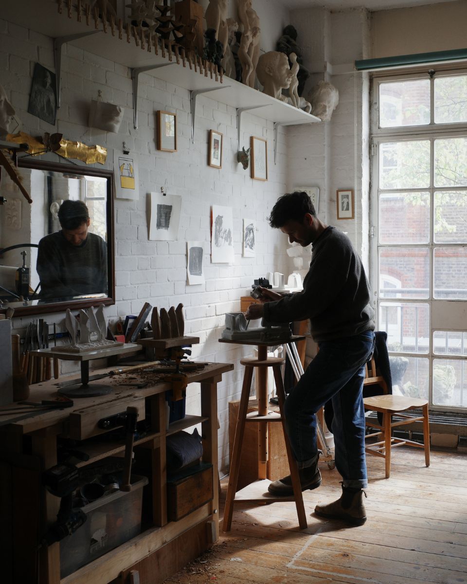 Artist Thomas Merrett at work creating art inside his creative studio space for the homepage What's New section.