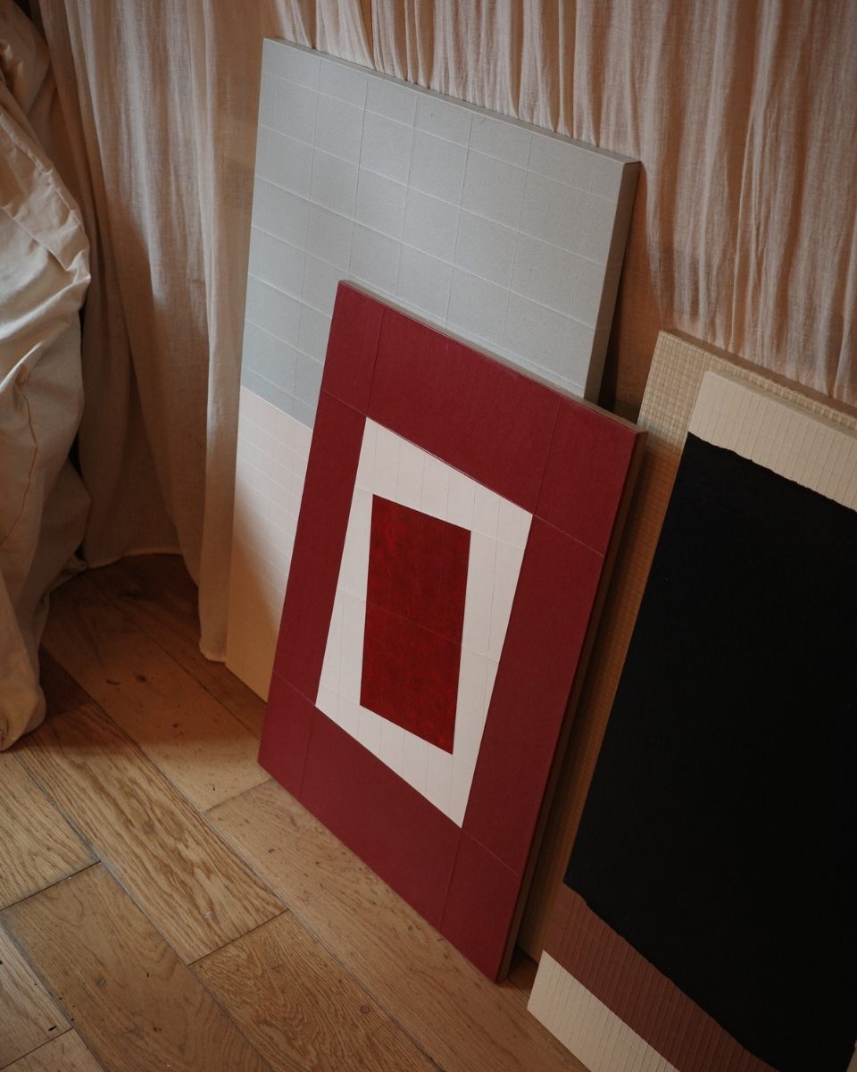 Close-up detail of Tom Collison’s artworks on Lokta paper, leaning against one another.