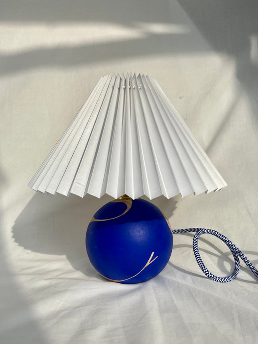 Hand painted wooden lamp by emerging artist Laxmi Hussain, featuring the female form in deep blue monochrome paint.
