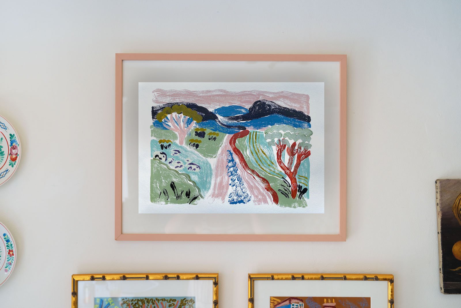 Unframed monoprint by Camilla Perkins, photographed in her studio. Hand-printed artwork depicting leafy scenery. 